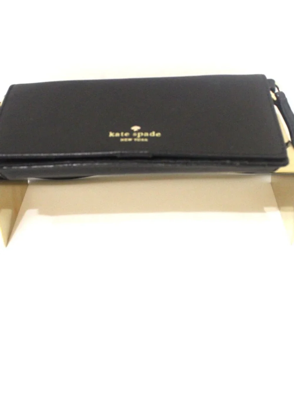The Kate Spade Bifold Wallet/Crossbody in Black Saffiano Leather is a stylish an